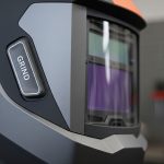 A close-up, high-detail shot of a modern auto-darkening welding helmet.